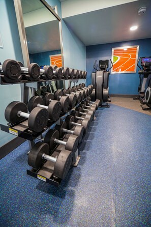 A gym with rows of dumbbells, exercise equipment, and a blue carpeted floor. - Four Points by Sheraton Salt Lake City Airport (Salt Lake City)