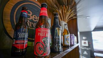 A bar with various bottles of beer, including Samuel Adams and Guinness.