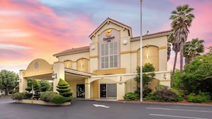 A Comfort Inn hotel with a traditional architectural style, featuring a large entrance, a covered parking area, and well-maintained landscaping. - Comfort Inn Fairfield Napa Valley Area (Fairfield)
