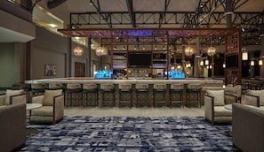 A bar area with a long counter, multiple bar stools, and a patterned rug. - Hilton Houston North (Houston)