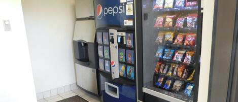 A vending machine area with a Pepsi refrigerator and a snack vending machine.