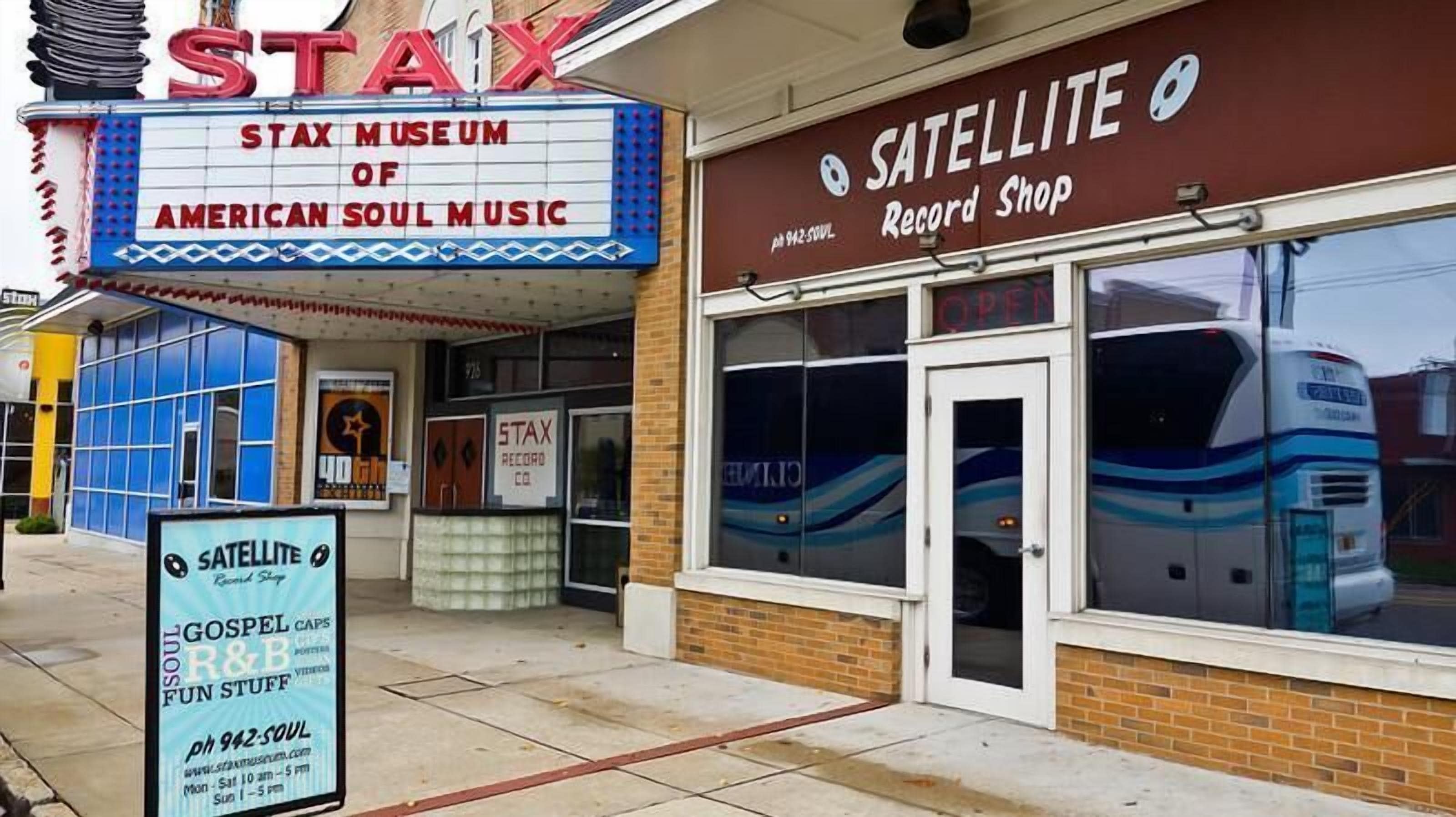 A building with a 'STAX' sign and a 'SATELLITE Record Shop' sign.