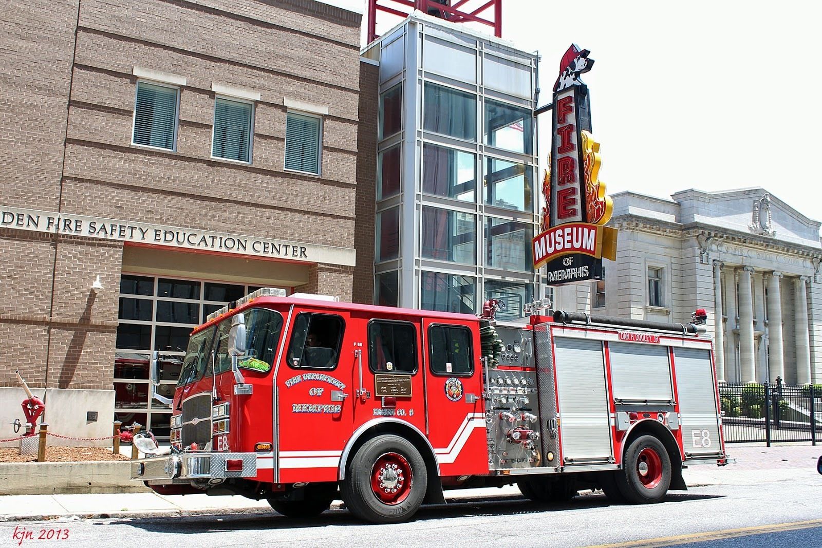 A fire truck parked in front of the Golden Fire Safety Education Center and the Museum of Memphis.