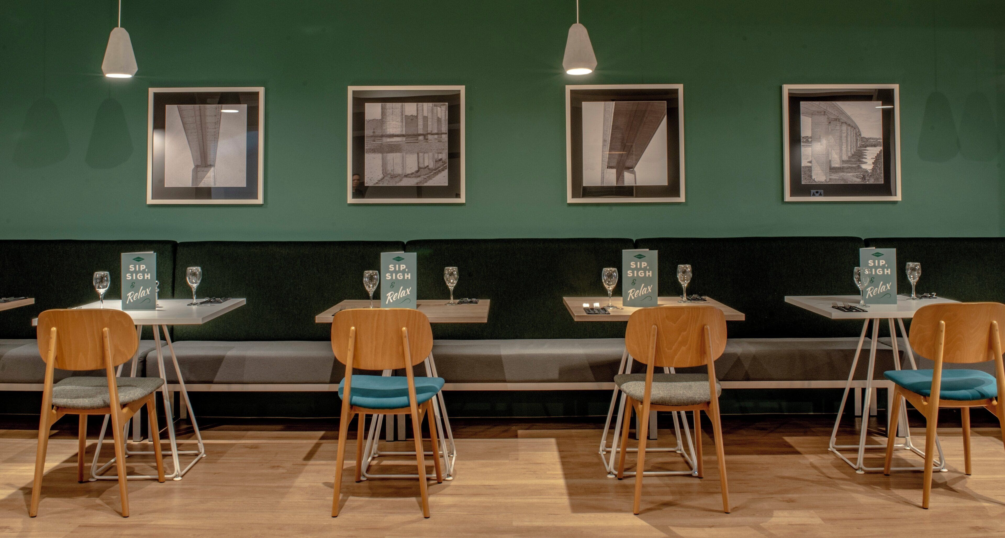 A restaurant interior with booths, tables, and chairs.
