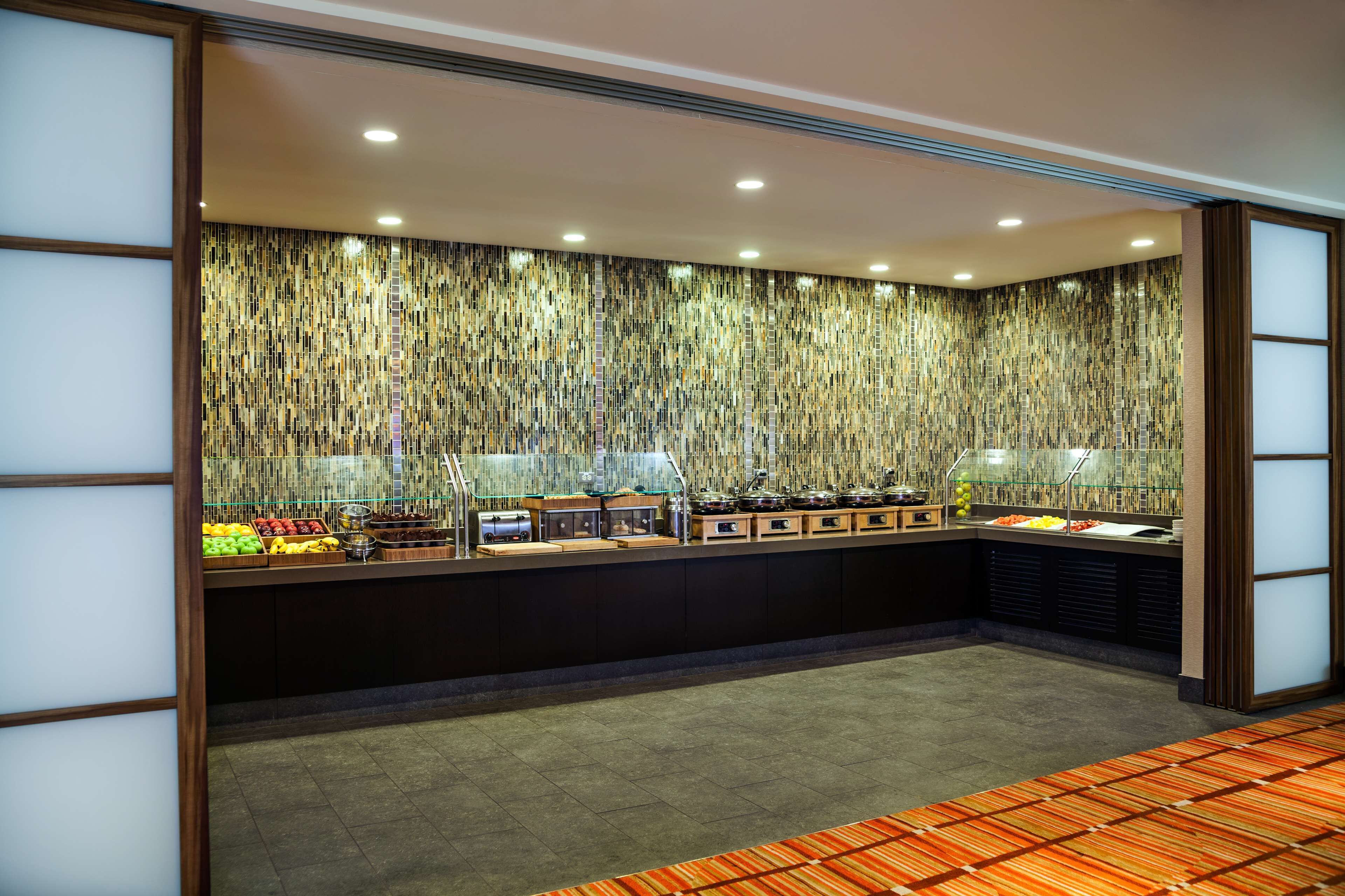 A buffet area with a variety of food items and kitchen appliances.