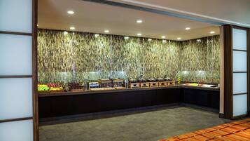 A buffet area with a variety of food items and kitchen appliances.