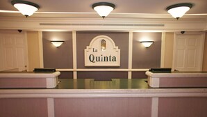 A reception area with a sign reading "La Quinta."