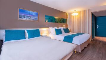 A hotel room with two beds, a painting, a lamp, and a view of the outside.