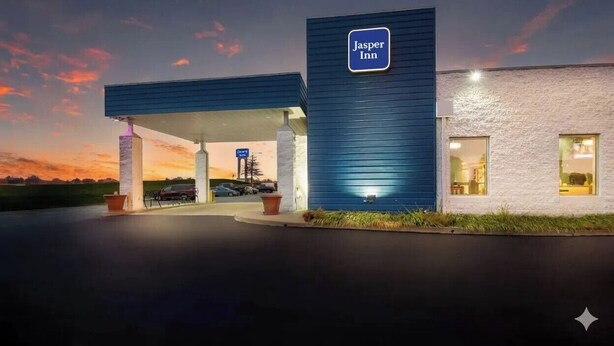 A Jasper Inn hotel with a modern design, featuring a prominent blue sign and a well-lit entrance. - Jasper Inn (Jasper)