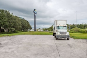 Guests can park their vehicles in the spacious parking area, surrounded by lush greenery.