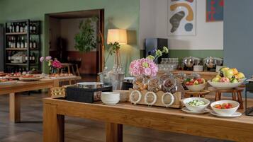 A buffet setup with various food items and a wine selection.