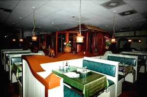 Un restaurante con cabinas y una zona central de comedor.