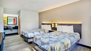 A modern hotel room with two beds, a bathroom, and a small sitting area. - Motel 6 Ashland, VA (Ashland)