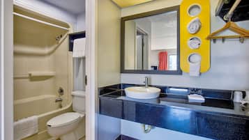 A bathroom with a bathtub, toilet, and sink.