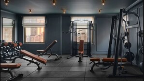 A gym with weight benches, dumbbells, and exercise machines. -  The Huntington Hotel (San Francisco)