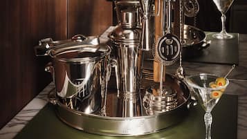 A set of silverware and a martini glass on a marble countertop.
