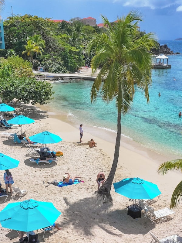 On the beach, white sand, sun loungers, beach umbrellas