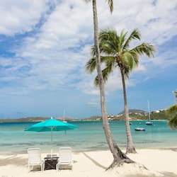 On the beach, white sand, sun loungers, beach umbrellas
