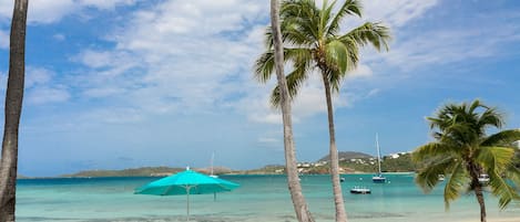 On the beach, white sand, sun-loungers, beach umbrellas