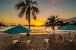 On the beach, white sand, sun-loungers, beach umbrellas