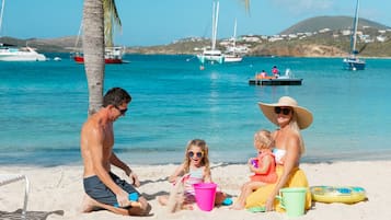 On the beach, white sand, sun loungers, beach umbrellas