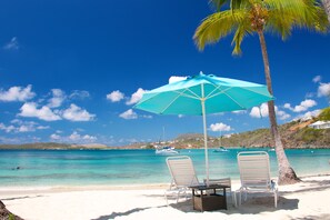 On the beach, white sand, sun-loungers, beach umbrellas