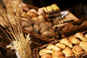 Baked goods are arranged in wicker baskets.