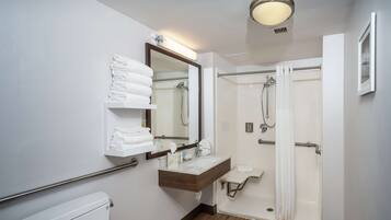 A modern bathroom with a toilet, sink, and shower.