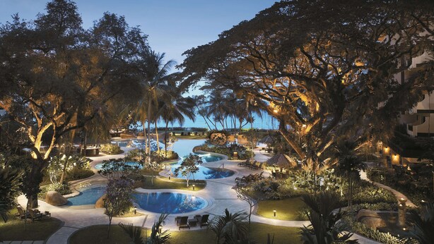 A resort with multiple swimming pools surrounded by lush vegetation and trees. - Shangri-La Rasa Sayang, Penang (George Town)