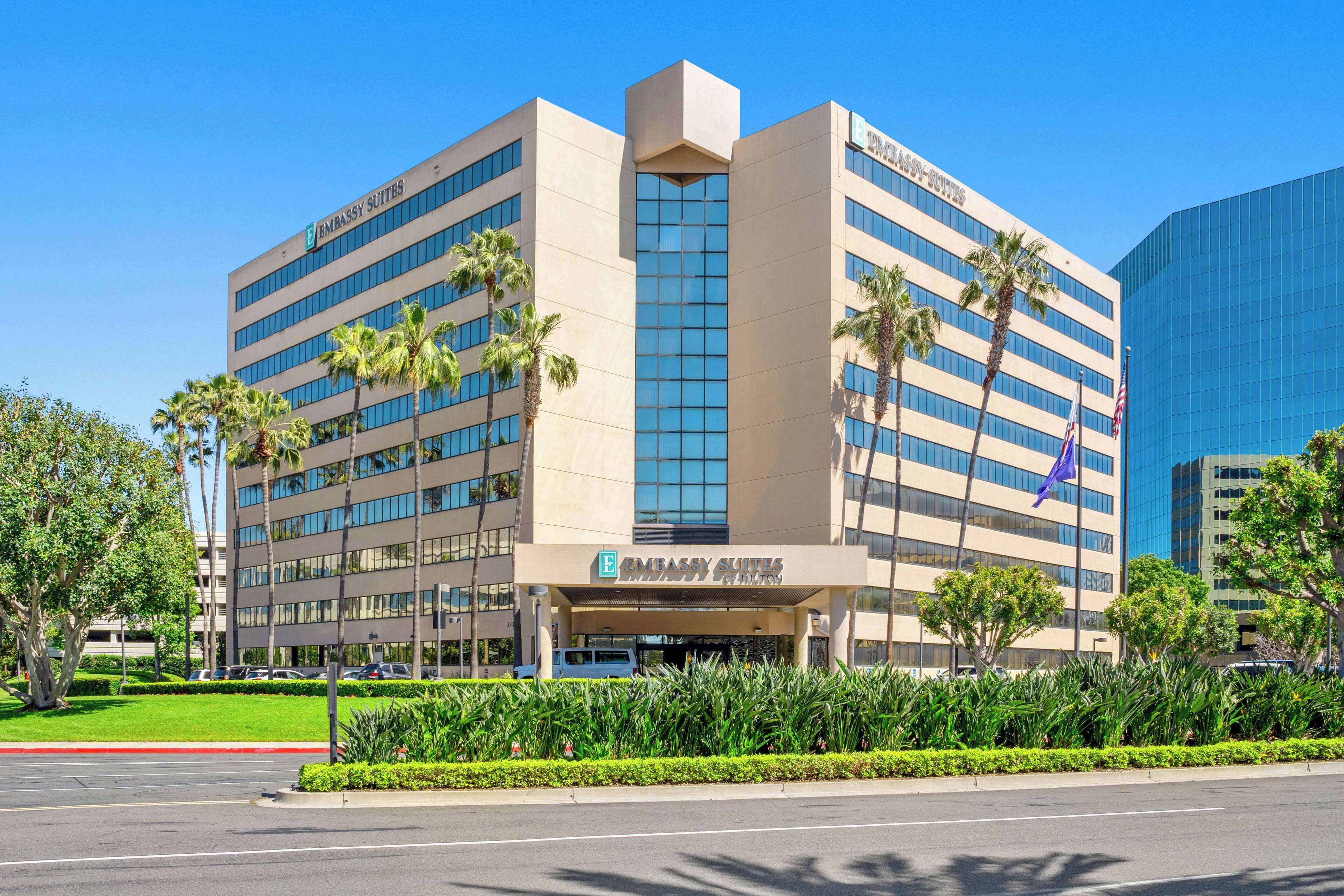 A modern building with a sign reading "Embassy Suites."