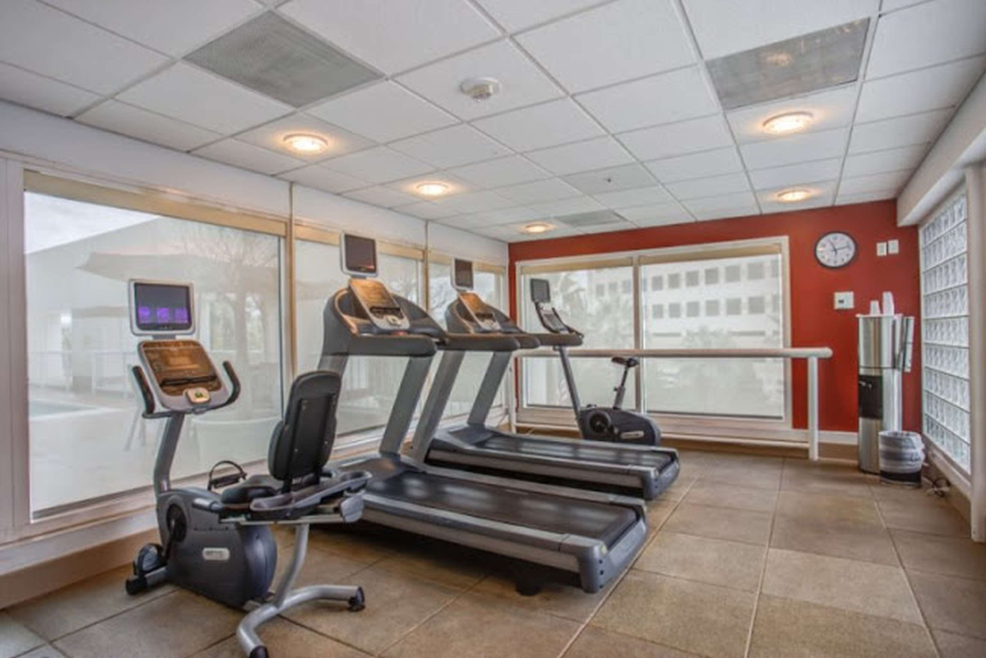 A fitness center with treadmills, an elliptical, and a stationary bike.
