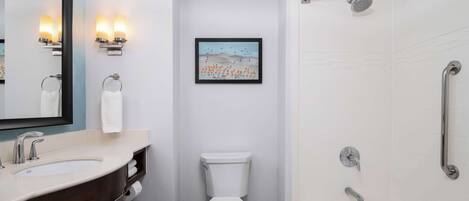 A modern bathroom with a sink, toilet, and bathtub.