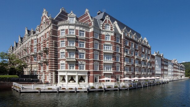 A large, historic building with multiple balconies and a waterfront view. - Hotel Europe Huis Ten Bosch (Sasebo)