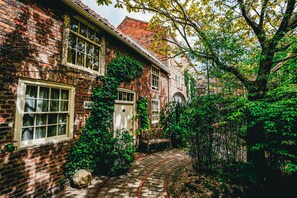 A brick house with a garden path, a bench, and a large tree. - York Pavilion Hotel, BW Signature Collection (York)