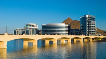 A bridge over water with modern buildings on either side.