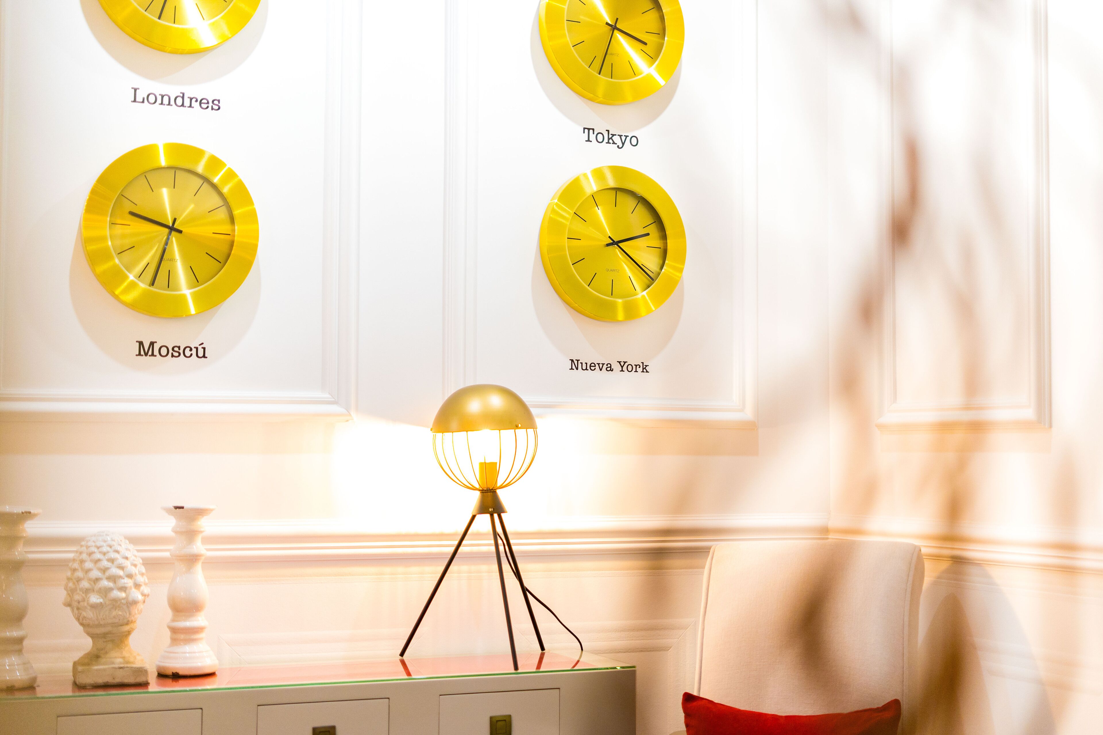A wall with four clocks labeled with city names.