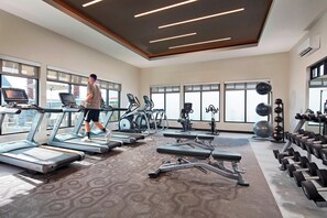 A modern gym with treadmills, elliptical machines, and a variety of weights. - Residence Inn by Marriott Manhattan Beach (Manhattan Beach)