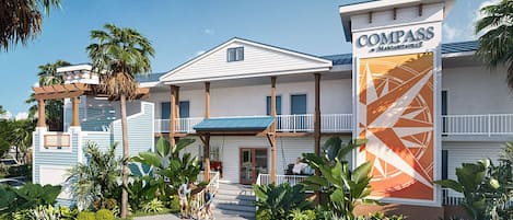 A hotel with a prominent sign reading 'COMPASS' and a covered entrance.