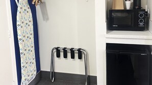 A compact kitchenette with a microwave, coffee maker, and a small refrigerator. - Lake Place Inn (Lake Havasu City)