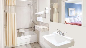 A bathroom with a bathtub, a sink, a shower with a handrail, a towel rack, and a mirror. - Days Inn by Wyndham Nashville North/Opryland Area (Nashville)