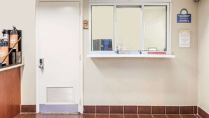 A clean, well-lit hallway with a door, a window with a view, and a wall-mounted sign. - Days Inn by Wyndham Nashville North/Opryland Area (Nashville)
