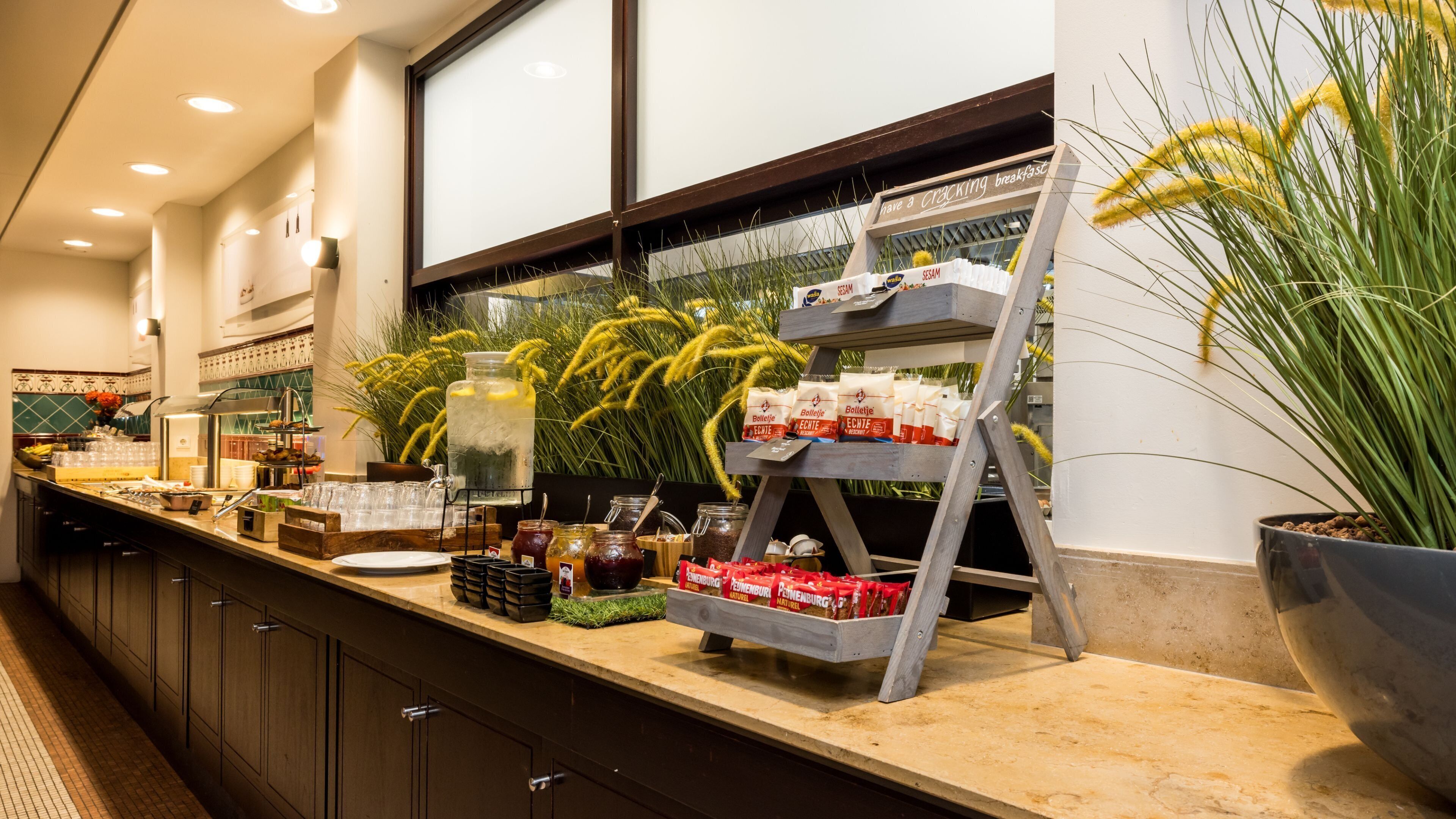 A buffet setup with various food items and condiments.
