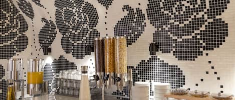 A modern kitchen with a mosaic backsplash, stainless steel appliances, and a buffet setup.
