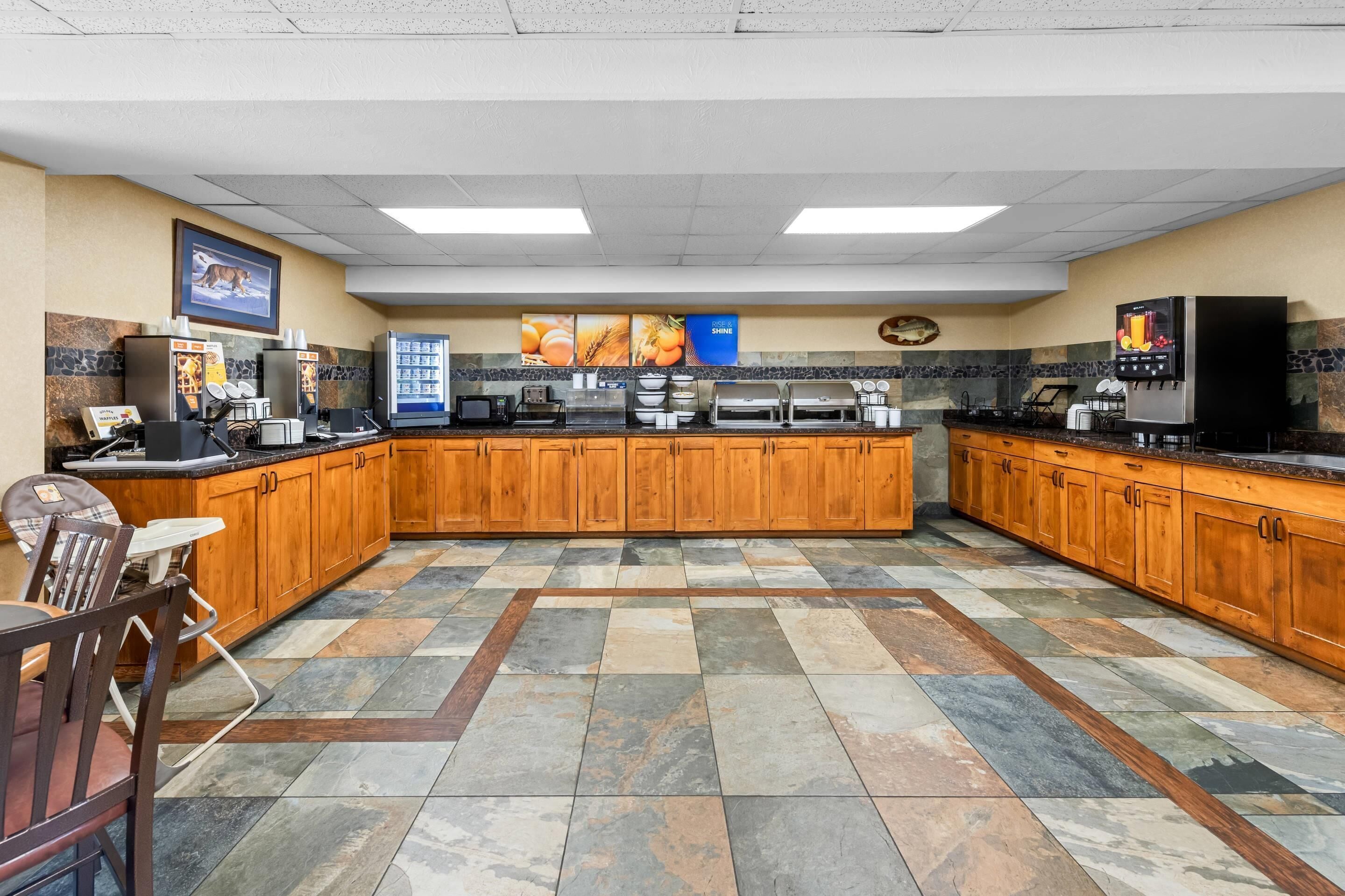 A spacious kitchen with a central island, equipped with various appliances and a coffee station.