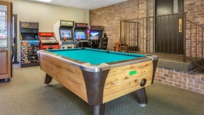 A pool table in a room with brick walls and a door. - Comfort Inn at Thousand Hills (Branson)
