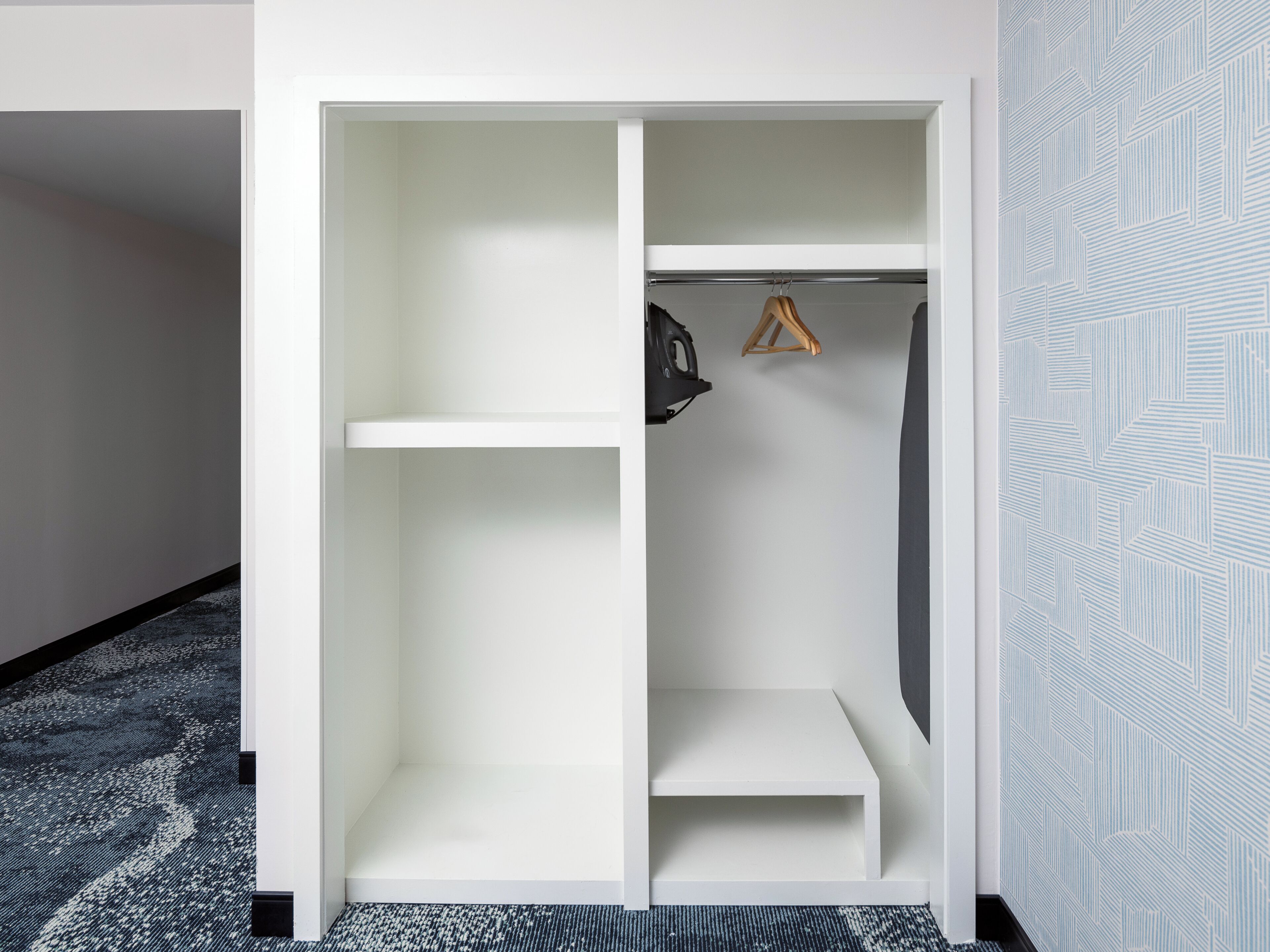 A walk-in closet with open shelves and hanging space.