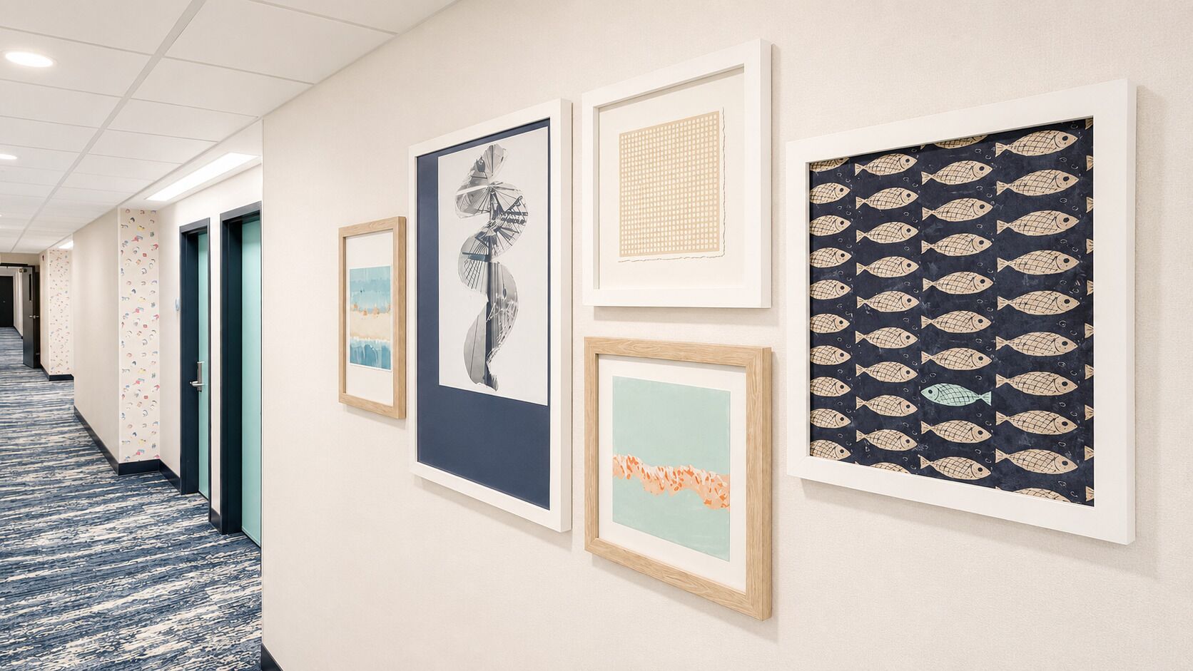 A hallway with framed artworks on the wall, a carpeted floor, and doors leading to rooms.