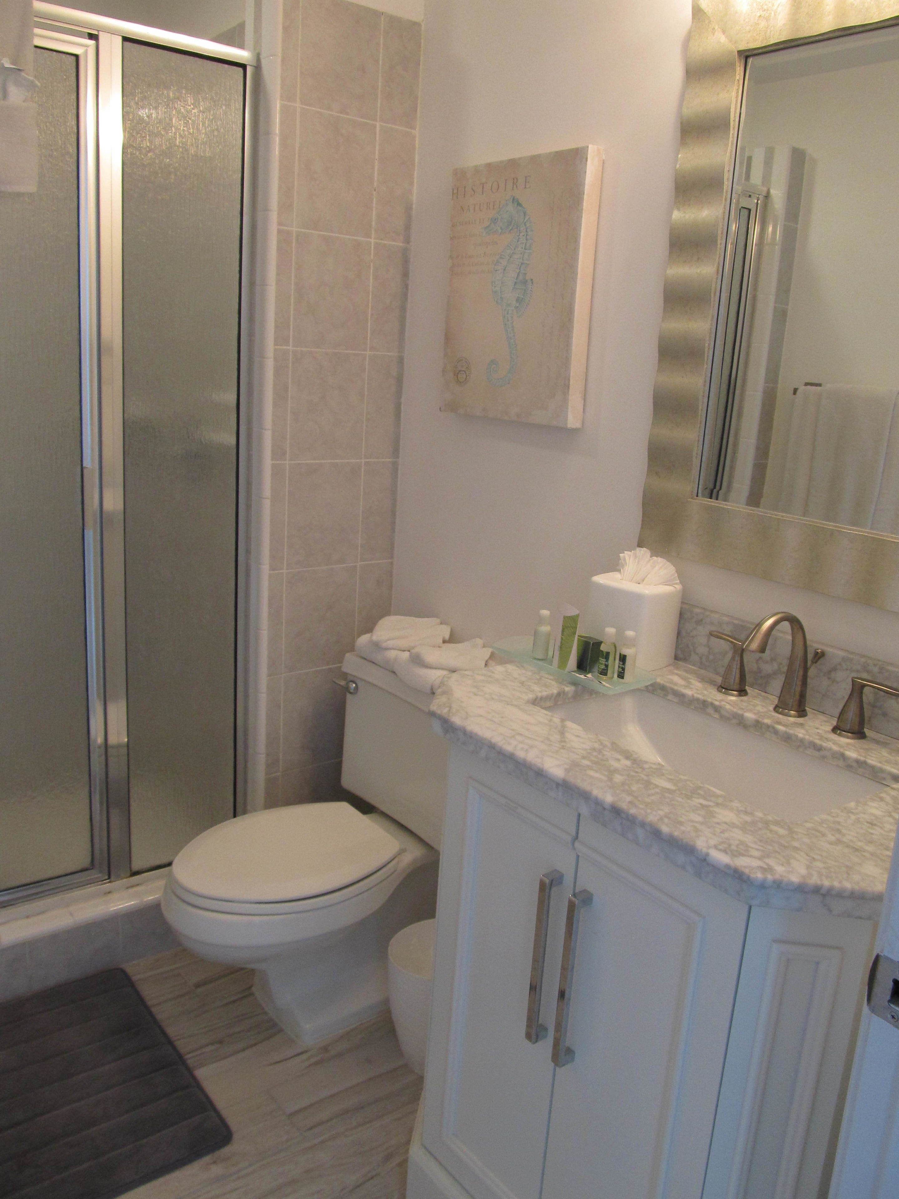 Ein Badezimmer mit Dusche, Toilette und Waschbecken.