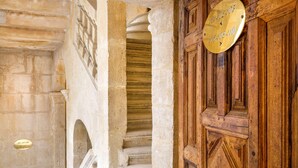 A stone staircase with a wooden door and a brass plaque.