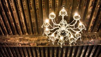 A chandelier with multiple arms and crystal decorations.